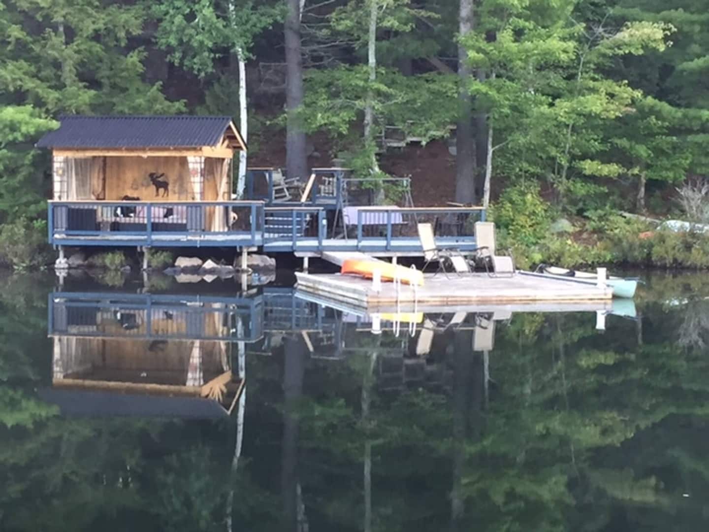 The lakeside gazebo and dock reflected in calm water on High Lake